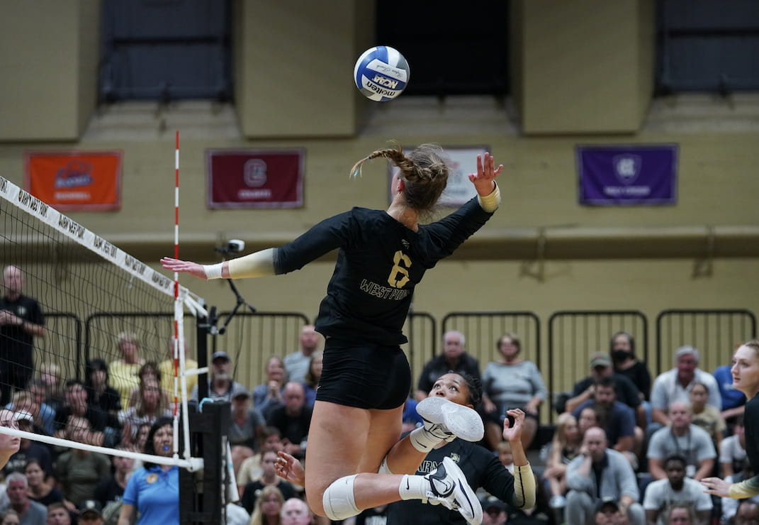 West Point Women's Volleyball Player in mid-air about to hit ball