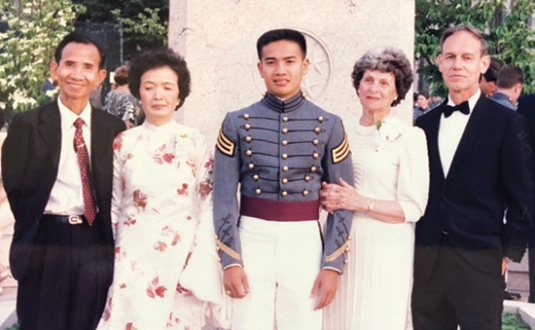 Pat Reardon '86 at his graduation with his birth parents and his adoptive parents