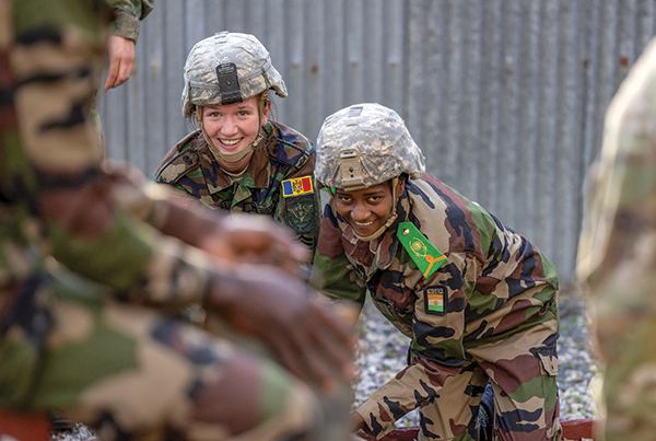 A FAEP cadet from Moldova (left) and one from Niger (right) work together at the Leaders Reaction Course.