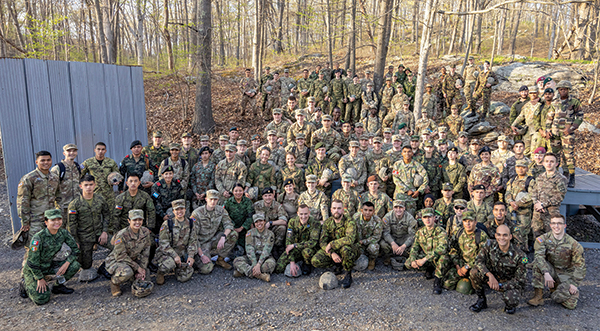 All 2023 FAEP participants, with their USMA host cadets, pose at the Leaders Reaction Course.