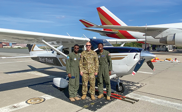 U.S. Air Force cadets Ruben Banks (left) and Zharia Wilson flank COL Richard Melnyk ’95, Director of the Academic Flight Program within the Department of Civil and Mechanical Engineering, before they embark on their second flight for their Overall Flight Lab project, which was to compare data collected in flight to theoretical data calculated prior to their flight.