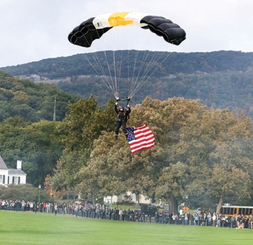 A member of the West Point Parachute Team practices flying the colors for demonstration jumps