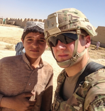 Tom Dunn '10 with local child in Kandahar Province, Afghanistan