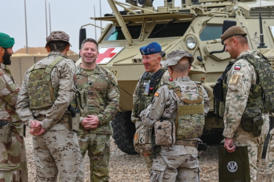 Then-LTC Russell Lemler ’01, in Al Asad, Iraq, celebrates with the command teams from Norway, Spain, and Poland.